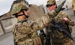 Kentucky Air National Guard Tech. Sgt. Bucky Harris (left), talks with Army Spc. Courtney Stewart (right), before a mission in southern Afghanistan of February 11, 2012. The two are deployed together as a part of the Kentucky National Guard's Agribusiness Development Team 4, which seeks to improve the lives of Afghan farmers by teaching better farming and sales techniques.