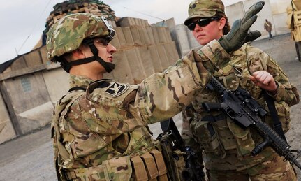 Kentucky Air National Guard Tech. Sgt. Bucky Harris (left), talks with Army Spc. Courtney Stewart (right), before a mission in southern Afghanistan of February 11, 2012. The two are deployed together as a part of the Kentucky National Guard's Agribusiness Development Team 4, which seeks to improve the lives of Afghan farmers by teaching better farming and sales techniques.