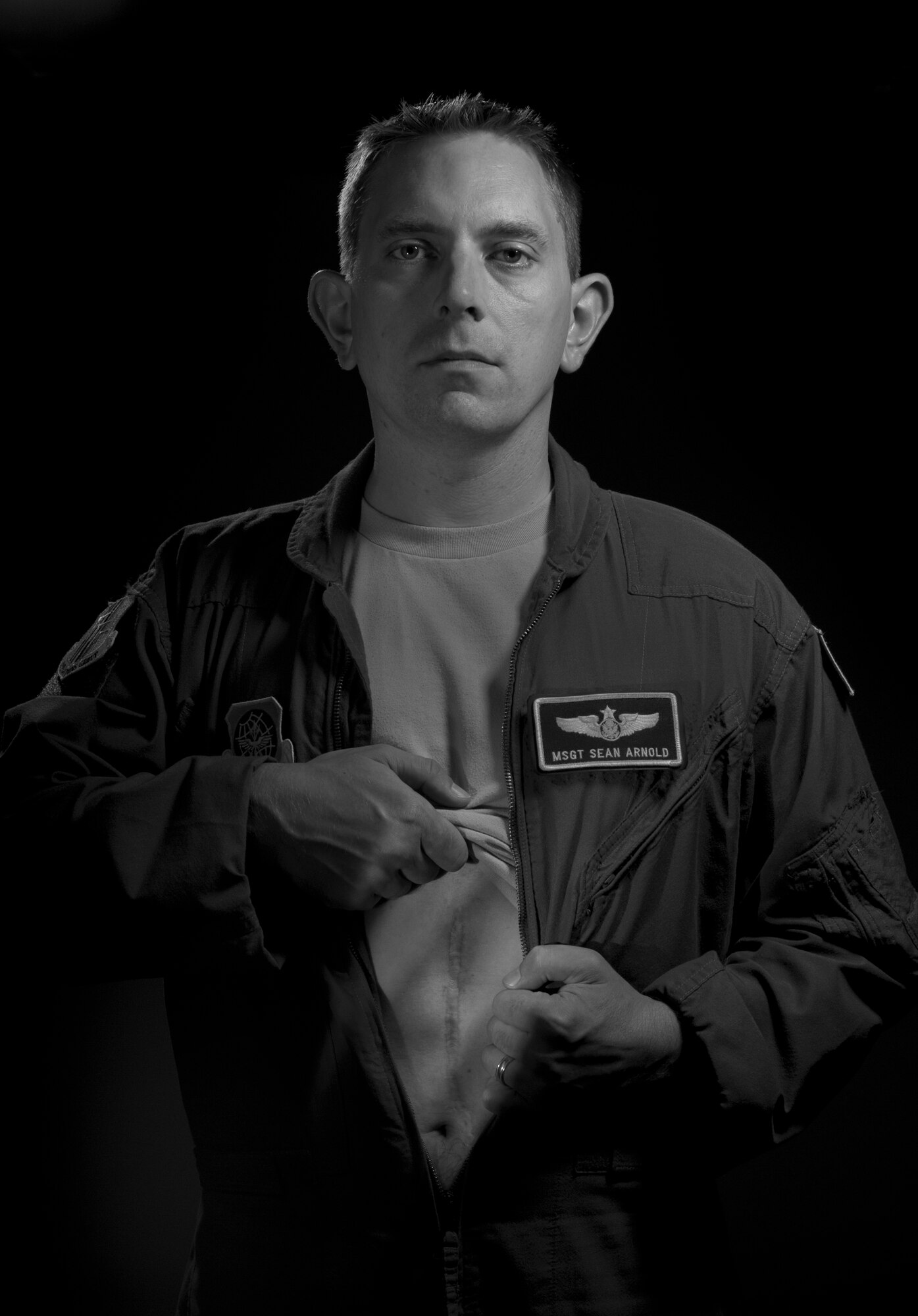 Master Sgt. Sean Arnold, 60th Operations Group resource manager, reveals the scar underneath his uniform from his February 2013 surgery for testicular cancer. Arnold diagnosis encouraged him to start a blog and spread the word to check for cancer. (Photo illustration/Senior Airman Madelyn Brown)