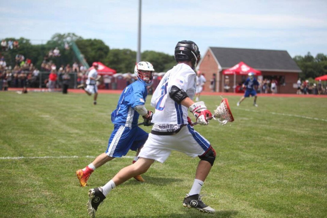 A team Valor and team Virtue player sprint down the field in the inaugural Dan Daly Cup all-star lacrosse game at Glen Cove High School June 21. The Cup showcased some of Long Island's top high school junior lacrosse players.