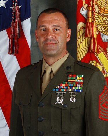 Michael Patrick Woods was born in Kansas City, Missouri in August 1974.  In October 1992, he graduated from Marine Corps Recruit Depot San Diego, California.  He completed Marine Combat Training at Camp Pendleton, California in November 1992. In March 1993, Private First Class Woods was assigned the military occupational specialty of 1812 at the Basic M1A1 Tank Crewman’s Course at Fort Knox, Kentucky.  From March 1993 to June 1994, he served as a tank driver and loader with Company B, 2d Tank Battalion, 2d Marine Division, Camp Lejeune, North Carolina.
       In October 1994, Lance Corporal Woods graduated from Marine Security Guard School and was transferred to the American Embassy in Rangoon Burma.  Upon completion of his tour, Corporal Woods was transferred to Company B, 2d Tank Battalion, 2d Marine Division, Camp Lejeune, North Carolina and meritoriously promoted to Sergeant.     
     In May 1996, Sergeant Woods deployed as a tank gunner with Battalion Landing Team (BLT) 1st Battalion, 8th Marines, 26th Marine Expeditionary Unit (MEU).  During this deployment he participated in Operation DECISIVE ENDEVOUR in the former Yugoslavia, Operation SILVER WAKE in Albania, and Operation DECISIVE ENDEAVOUR in Zaire, Africa.  
     In 1997, Sergeant Woods deployed as a tank commander with BLT 3d Battalion, 6th Marines, 24th MEU.  During this deployment he participated in Operation JOINT GUARD in Yemen, and Operation DESERT THUNDER in Kuwait. 
     In 1998 and 1999, Sergeant Woods served as a M1A1 Tank Platoon Sergeant and Platoon Commander in Company C, 2d Tank Battalion.  
     In January 2000, Staff Sergeant Woods reported for duty with Company B, First Recruit Training Battalion, Recruit Training Regiment, Parris Island, South Carolina.  He served as a Drill Instructor, Senior Drill Instructor, and Staff Noncommissioned Officer in Charge of the Water Survival Section.  
     In January 2003, Staff Sergeant Woods participated in the invasion of Iraq as an M1A1 Ta
