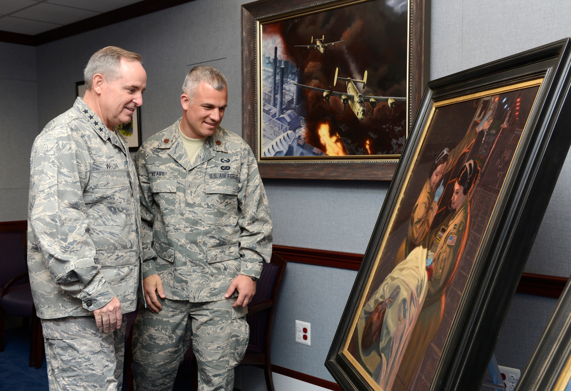 Air Force Chief of Staff Gen. Mark A. Welsh III looks at the painting, "Bandage 33," June 20, 2014, with the artist, Maj. Warren Neary, in the Pentagon. Neary, a U.S. Air Force Reserve historian, contributed "Bandage 33" and another work, titled "Showtime," through the Air Force Art Program. (U.S. Air Force photo/Scott M. Ash)