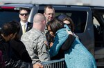 First Lady Michelle Obama hugs Jennie Schueller, the wife of Army Staff Sgt. Andrew Schueller, of Missouri Army National Guard's the 1-138th Infantry Regiment, during a meet and greet on March 5, 2012 at Kansas City International Airport. The first lady greeted the Guard members and their families while passing through Kansas City.