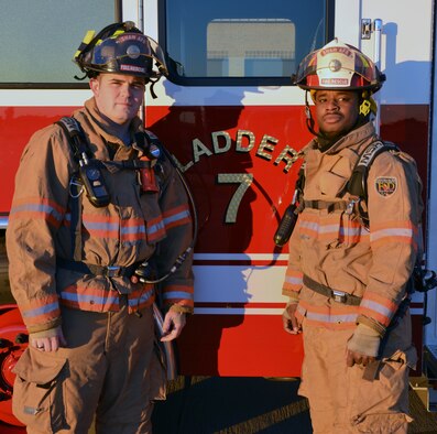 Senior Airman Boyd Korb, a 20th Civil Engineer Squadron firefighter, left, and Tech. Sgt. Joseph Charleston, the 20th CES station captain, stand in front of Ladder Truck 7 Dec. 18, 2013, on Shaw Air Force Base, S.C. Charleston and Korb received the Defense Department McAllister Outstanding Fire Department Team Award for Heroism April 9, 2013, for their actions directly related to saving the life of a civilian firefighter in Sumter, S.C. (Courtesy photo)