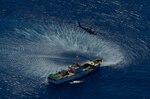 An HH-60G Pave Hawk rescue helicopter from the California Air National Guard's 129th Rescue Wing hovers over the Chinese fishing vessel Fu Yuan Yu #871, March 12, 2012. Guardian Angel Pararescuemen from the wing rescued two fishermen who were burned in a diesel fire onboard the vessel more than 700
miles off the coast of Acapulco, Mexico.