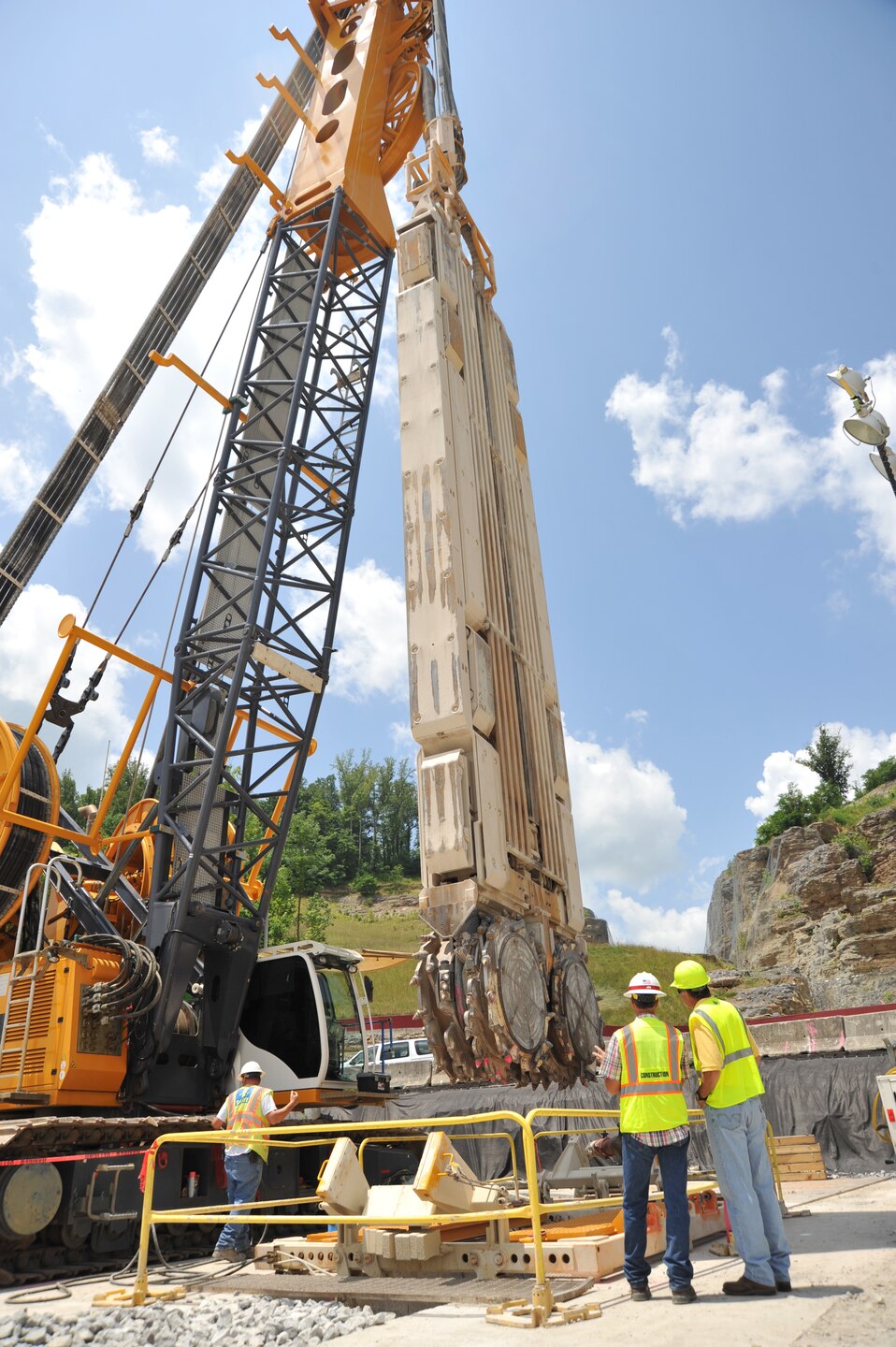 Pat Haas, chief of the Chemical Demilitarization Directorate, talks with John Schnebelen, Center Hill Dam Construction Safety Technician, about the massive drilling equipment, custom built by contractor Bauer Foundation Corporation for the Center Hill dam foundation rehabilitation project. Haas participated as a mentor for Huntsville Center's Leadership Development Program field trip to Nashville District's Center Hill Dam project June 17.