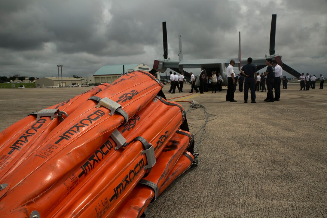 Senior fire officers observe a static display of the Bambi Bucket firefighting water delivery system and MV-22B Osprey tiltrotor aircraft during an MLC Senior Officer Session at Marine Corps Air Station Futenma June 10. The Bambi Bucket is a firefighting tool that can hold up to 7,600 pounds of water or fire retardant foam used to fight wildfires. The senior fire officers are with fire and emergency services across numerous U.S. installations on Okinawa. (U.S. Marine Corps photo by Lance Cpl. Tyler Ngiraswei/Released)