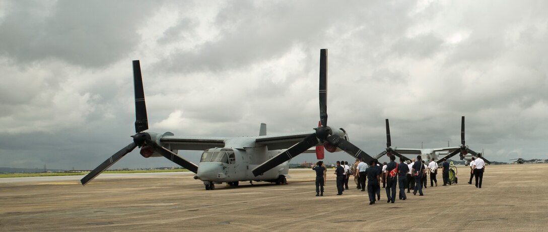 Senior fire officers make their way toward a static display of the Bambi Bucket firefighting water delivery system and MV-22B Osprey tiltrotor aircraft during an MLC Senior Officer Session at Marine Corps Air Station Futenma June 10. The Bambi Bucket is a firefighting tool that can hold up to 7,600 pounds of water or fire retardant foam used to fight wildfires. The senior fire officers are with fire and emergency services across numerous U.S. installations on Okinawa. (U.S. Marine Corps photo by Lance Cpl. Tyler Ngiraswei/Released)  