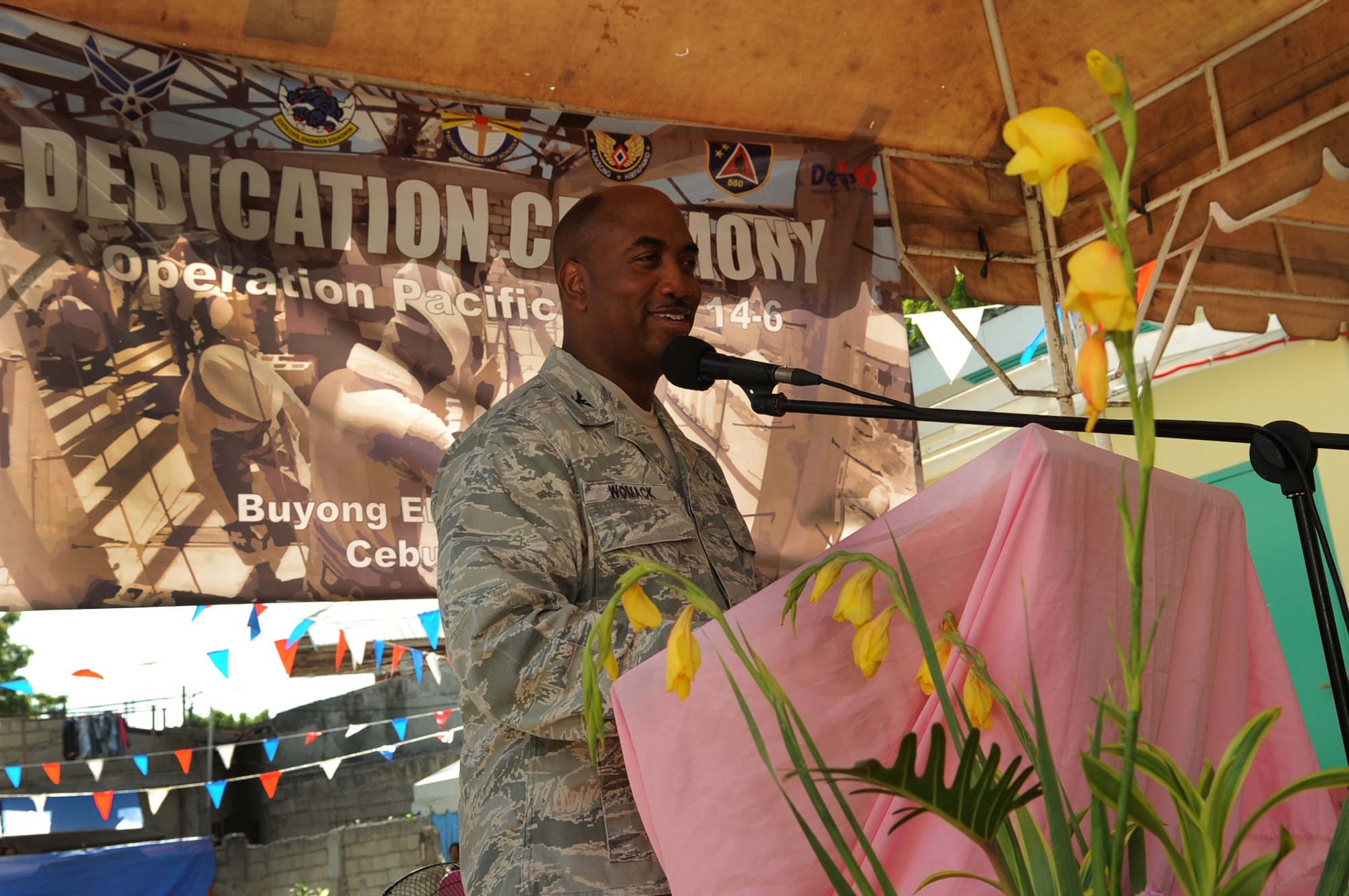 U.S. Air Force Col. John Womack, Pacific Air Force chief of combat support integration division, Joint Base Pearl Harbor-Hickam, Hawaii, speaks during the building dedication and closing ceremony of Operation Pacific Unity 14-6 at Buyong Elementary School in Barangay Maribago, Lapu-Lapu City, Philippines, June 20, 2014. Pacific Unity is a bilateral Engineering Civic Action Program conducted in the Asia-Pacific region in collaboration with host nation military personnel. Airmen from the 374th CES spent 31 days building two classrooms and renovating utilities throughout the school. (U.S. Air Force photo by Staff Sgt. Amber E. N. Jacobs/Released)
