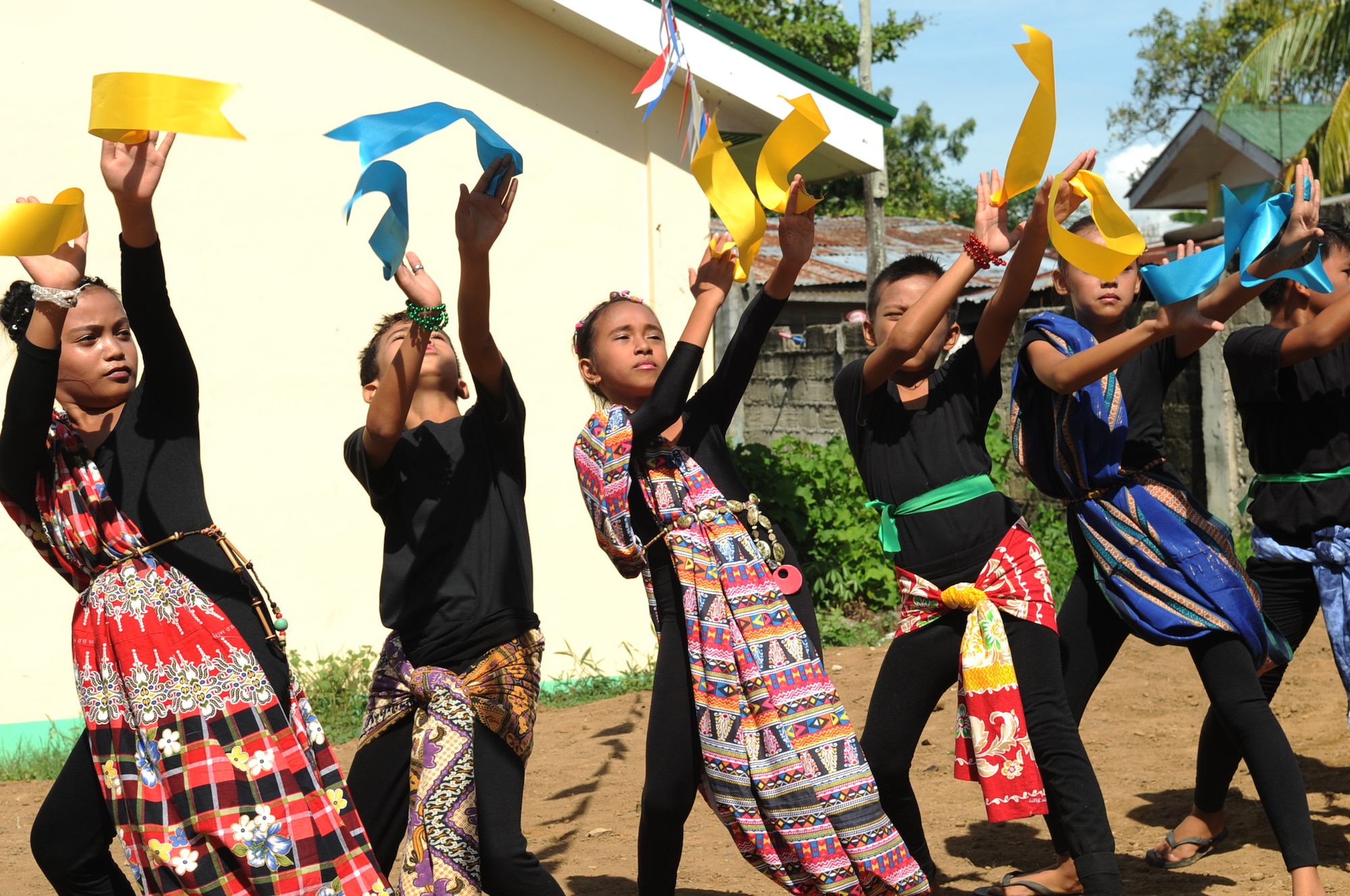 Elementary students perform a dance during the closing ceremony of Operation Pacific Unity 14-6 at Buyong Elementary School in Barangay Maribago, Lapu-Lapu City, Philippines, June 20, 2014. The students showed their appreciation through a cultural display at the ceremony. Pacific Unity is a bilateral Engineering Civic Action Program conducted in the Asia-Pacific region in collaboration with host nation military personnel. One of the main focuses of the program is to strengthen ties with Pacific allies while promoting positive U.S. relations within the region. (U.S. Air Force photo by Staff Sgt. Amber E. N. Jacobs/Released)