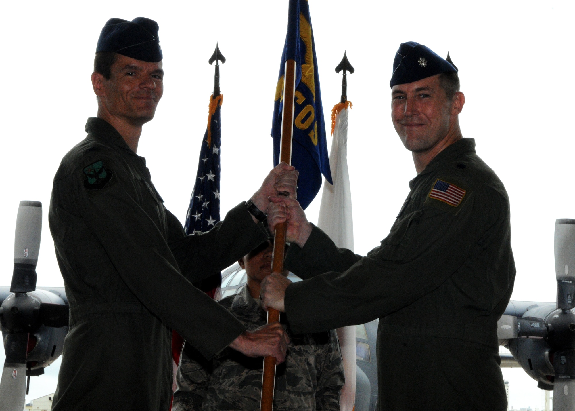 Lt. Col. Shane Vesely, 1st Special Operations Squadron incoming commander, accepts the guidon from Col. Benjamin Maitre, 353rd Special Operations Group commander, during a change of command ceremony on Kadena Air Base, Japan, June 2, 2014. (U.S. Air Force photo by Tech. Sgt. Kristine Dreyer)
