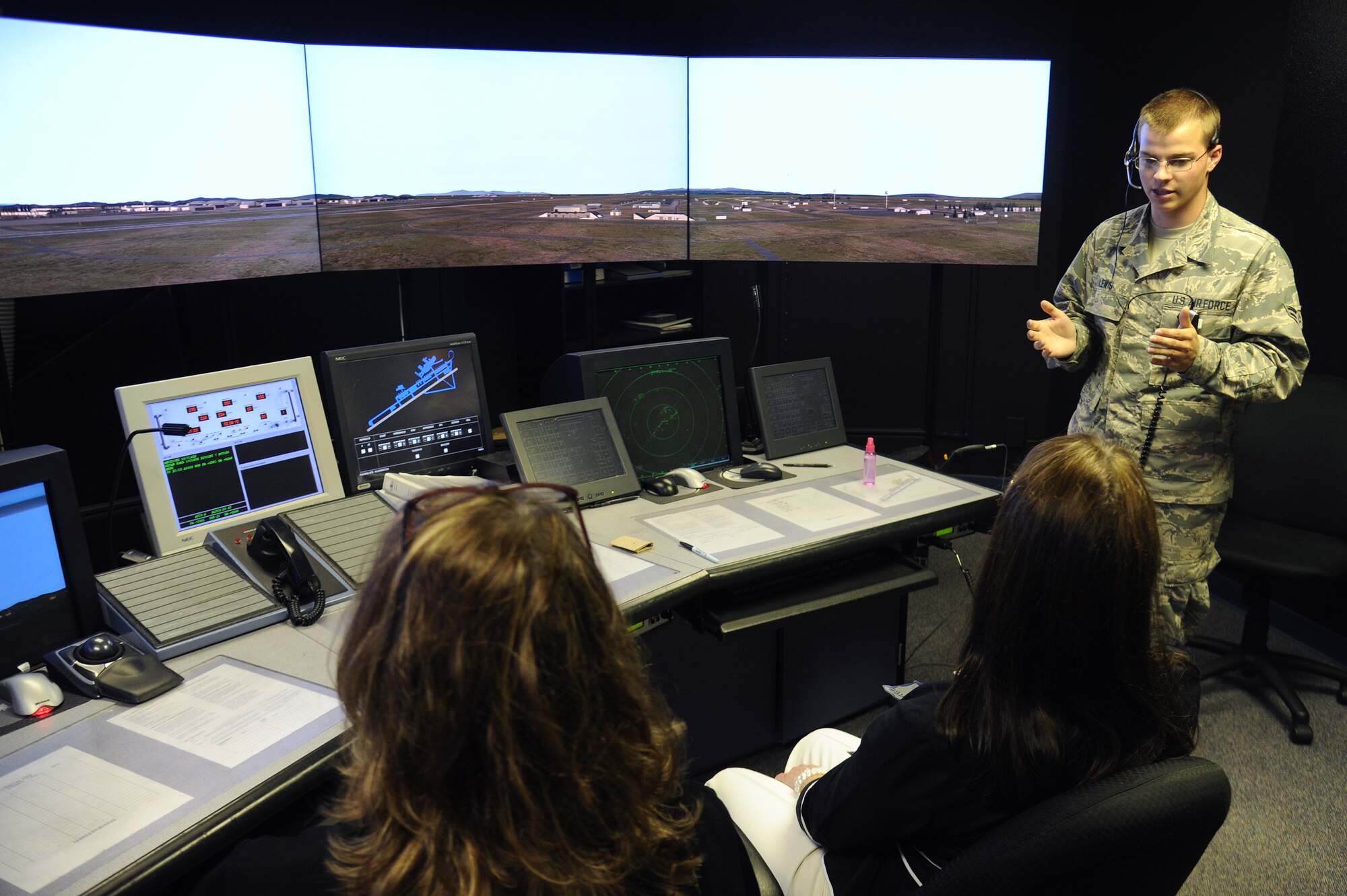 Family and friends of those involved in the fatal hospital shooting that took place 20 years ago at Fairchild Air Force Base, Wash., look out from the control tower during a tour of the base, June 20, 2014. These individuals received a tour as part of a base-wide remembrance for the lives lost that day in 1994, when an active-shooter opened fire in the base hospital. (U.S. Air Force photo by Airman 1st Class Janelle Patiño/Released)