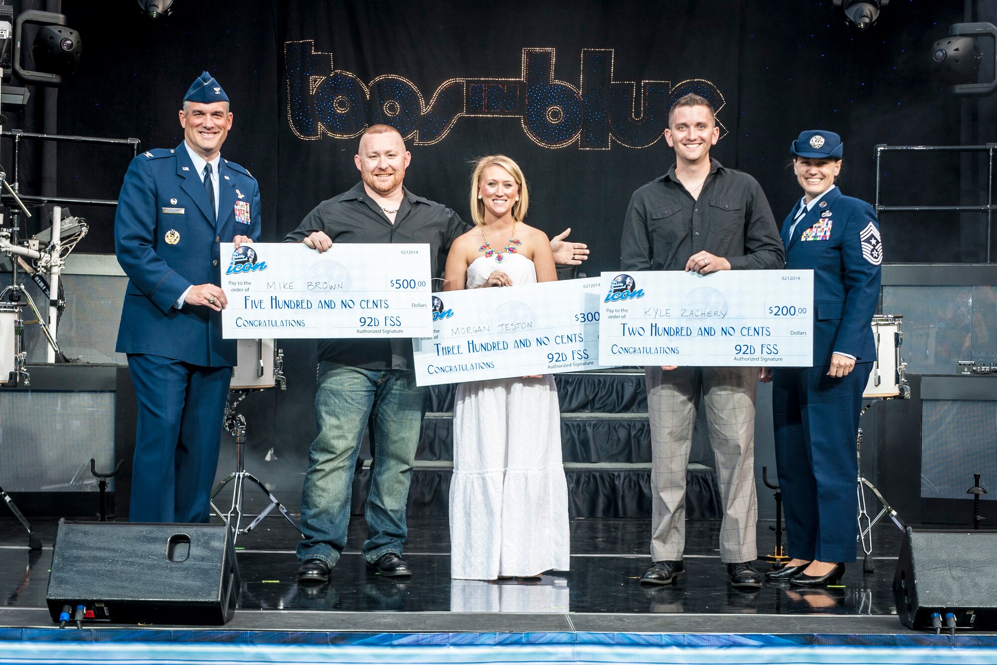 Fairchild Air Force Base’s AMC Icon vocal competition winners pose with Col. Brian Newberry and Chief Master Sgt. Wendy Hansen at the Riverfront Park Lilac Bowl in Spokane, Wash., June 21, 2014. The AMC Icon program is loosely based around the hit TV program, American Idol, and allows local contestants to compete for $1,000 in cash prizes. The top active duty Air Force vocalist will then compete for $2,000 in cash prizes at the command level. Newberry is the 92nd Air Refueling Wing commander and Hansen is the 92nd ARW command chief. (U.S. Air Force photo by Staff Sgt. Benjamin W. Stratton/Released)