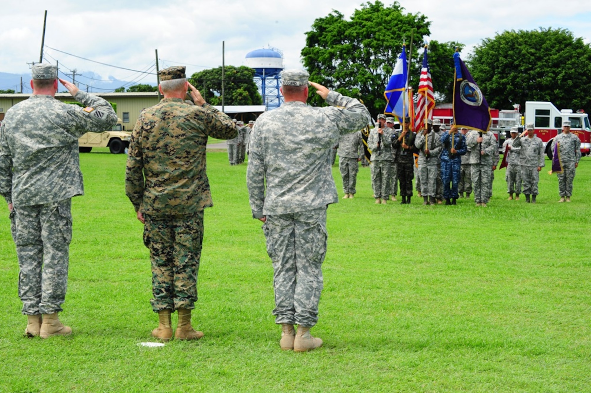 U. S. Army Col. Kirk C. Dorr (left), U. S. Marine Gen. John F. Kelly, U. S. Southern Command commander, and U. S. Army Col. Thomas D. Boccardi salute the Honduras and American flag during the Joint Task Force-Bravo change of command ceremony at Soto Cano Air Base, Honduras, June 23, 2014. Col. Dorr assumed command from Col. Boccardi.  (Photo by U. S. Air National Guard Capt. Steven Stubbs)