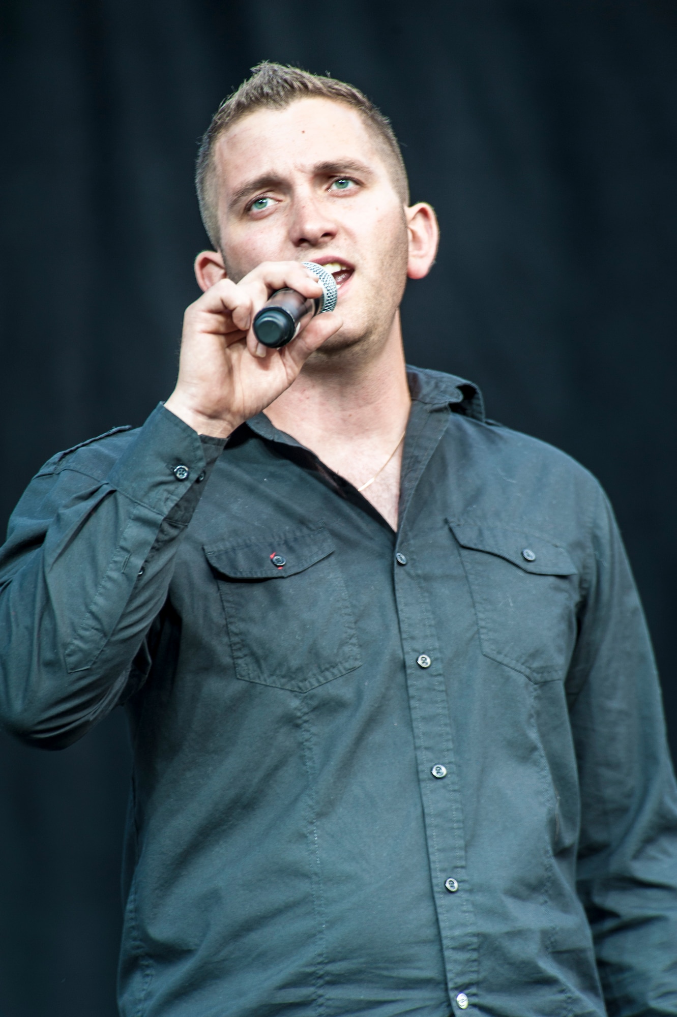 Senior Airman Kyle Zachery sings “All of me” by John Legend during the AMC Icon vocal competition at the Riverfront Park Lilac Bowl in Spokane, Wash., June 21, 2014. The AMC Icon program is loosely based around the hit TV program, American Idol, and allows local contestants to compete for $1,000 in cash prizes. The top active duty Air Force vocalist will then compete for $2,000 in cash prizes at the command level. Zachery earned third place in Fairchild Air Force Base’s competition winning $200 and is a 92nd Aircraft Maintenance Squadron crew chief. (U.S. Air Force photo by Staff Sgt. Benjamin W. Stratton/Released)