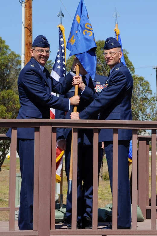 Col. Todd Schollars accepts the 30th Mission Support Group guidon from Col. Keith Balts, 30th Space Wing commander, during a change of command ceremony June 24, 2014 Vandenberg Air Force Base, Calif. The 30th MSG provides security, law enforcement, disaster response, civil engineer, base services, mission support, morale services, contracting, and logistical support for Vandenberg AFB. (U.S. Air Force photo by Airman 1st Class Yvonne Morales/ Released)