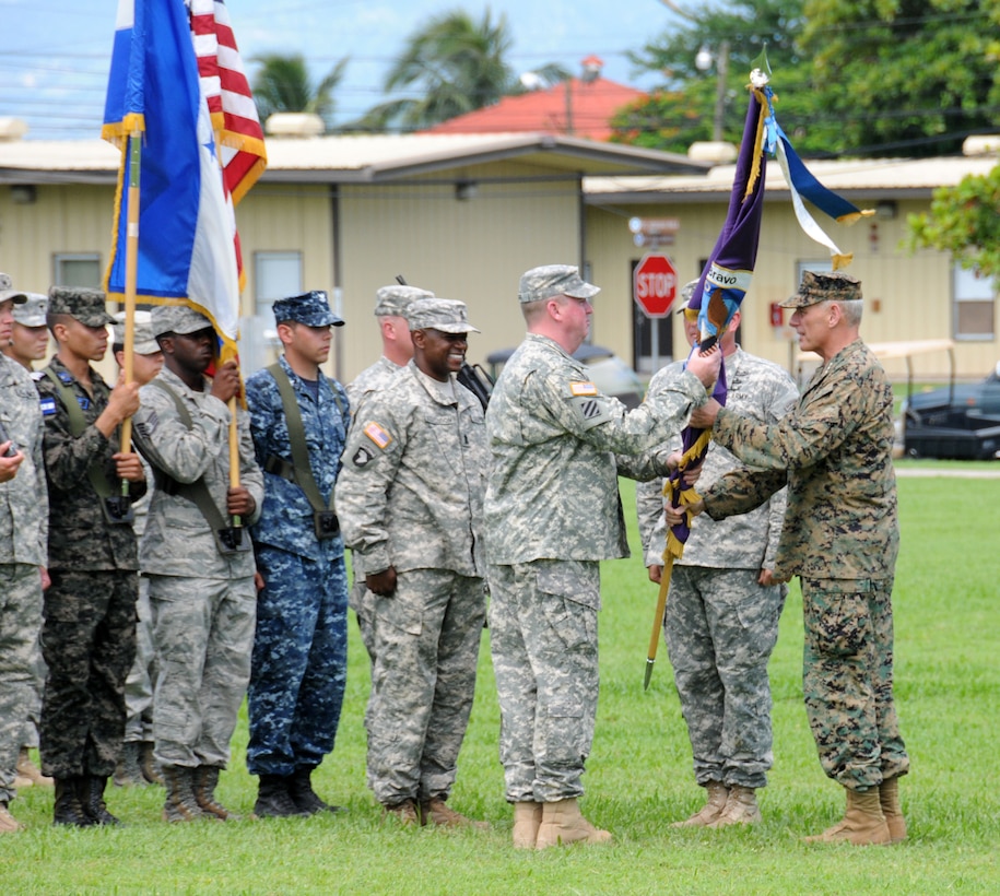 U. S. Army Col. Kirk C. Dorr assumes command of Joint Task Force- Bravo, at Soto Cano Air Base, Honduras by accepting the guidon from U. S. Marine Gen. John F. Kelly, the U.S. Southern Command commander June 23, 2014. Col. Dorr assumed command from U. S. Army Col. Thomas D. Boccardi. JTF-Bravo conducts a variety of missions in Central America from supporting U.S. Government operations to counter transnational crime to humanitarian assistance/disaster relief and building partner capacities.  (Photo by U. S. Air National Guard Capt. Steven Stubbs)