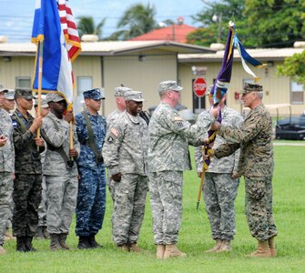 U. S. Army Col. Kirk C. Dorr assumes command of Joint Task Force- Bravo, at Soto Cano Air Base, Honduras by accepting the guidon from U. S. Marine Gen. John F. Kelly, the U.S. Southern Command commander June 23, 2014. Col. Dorr assumed command from U. S. Army Col. Thomas D. Boccardi. JTF-Bravo conducts a variety of missions in Central America from supporting U.S. Government operations to counter transnational crime to humanitarian assistance/disaster relief and building partner capacities.  (Photo by U. S. Air National Guard Capt. Steven Stubbs)