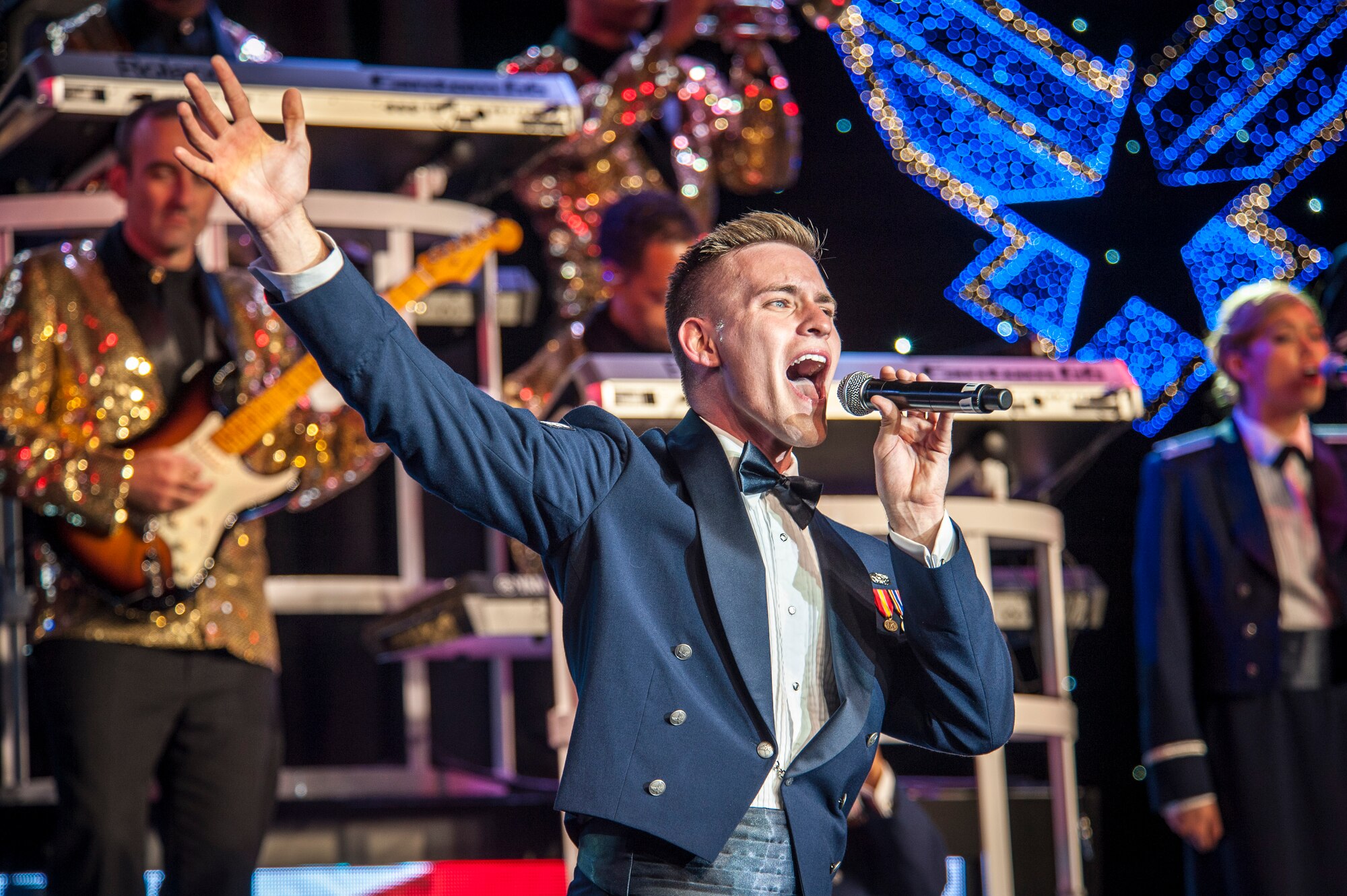 Senior Airman Jeremiah Barnes performs for the Spokane community and Team Fairchild during the Tops In Blue show at the Riverfront Park Lilac Bowl in Spokane, Wash., June 21, 2014, while on their 60th anniversary tour with performances ranging from classic rock to today’s Top 40 hits. Tops In Blue is the Air Force’s premier entertainment showcase team and composed of 35 to 40 of the most talented vocalists, musicians, dancers, and technicians anywhere. Their primary purpose is to perform for military personnel and their families throughout the world. Barnes is a vocalist and a 56th Communications Squadron cyber systems operations journeyman from Luke Air Force Base, Ariz., and a Nashville, Tenn., native. (U.S. Air Force photo by Staff Sgt. Benjamin W. Stratton/Released)