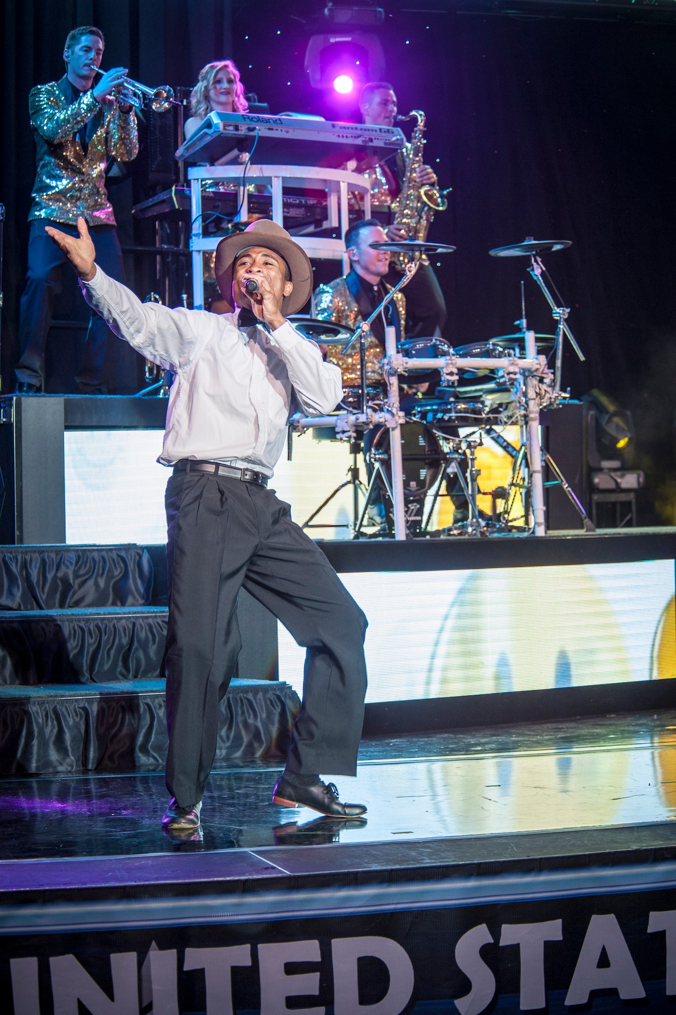 Senior Airman Charles Cooper performs for the Spokane community and Team Fairchild during the Tops In Blue show at the Riverfront Park Lilac Bowl in Spokane, Wash., June 21, 2014, while on their 60th anniversary tour with performances ranging from classic rock to today’s Top 40 hits. Tops In Blue is the Air Force’s premier entertainment showcase team and composed of 35 to 40 of the most talented vocalists, musicians, dancers, and technicians anywhere. Their primary purpose is to perform for military personnel and their families throughout the world. Cooper is a vocalist and a 509th Logistics Readiness Squadron vehicle operations journeyman from Whiteman Air Force Base, Mo., and a St. Louis, Mo., native. (U.S. Air Force photo by Staff Sgt. Benjamin W. Stratton/Released)