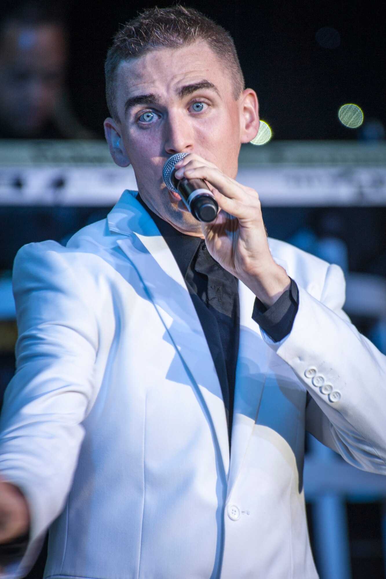 Airman 1st Class Kyle McCarty performs for the Spokane community and Team Fairchild during the Tops In Blue show at the Riverfront Park Lilac Bowl in Spokane, Wash., June 21, 2014, while on their 60th anniversary tour with performances ranging from classic rock to today’s Top 40 hits. Tops In Blue is the Air Force’s premier entertainment showcase team and composed of 35 to 40 of the most talented vocalists, musicians, dancers, and technicians anywhere. Their primary purpose is to perform for military personnel and their families throughout the world. McCarty is a vocalist and a 15th Aircraft Maintenance Squadron aircraft maintenance journeyman from Joint Base Pearl Harbor-Hickam, Hawaii, and a Berlin, N.J., native. (U.S. Air Force photo by Staff Sgt. Benjamin W. Stratton/Released)