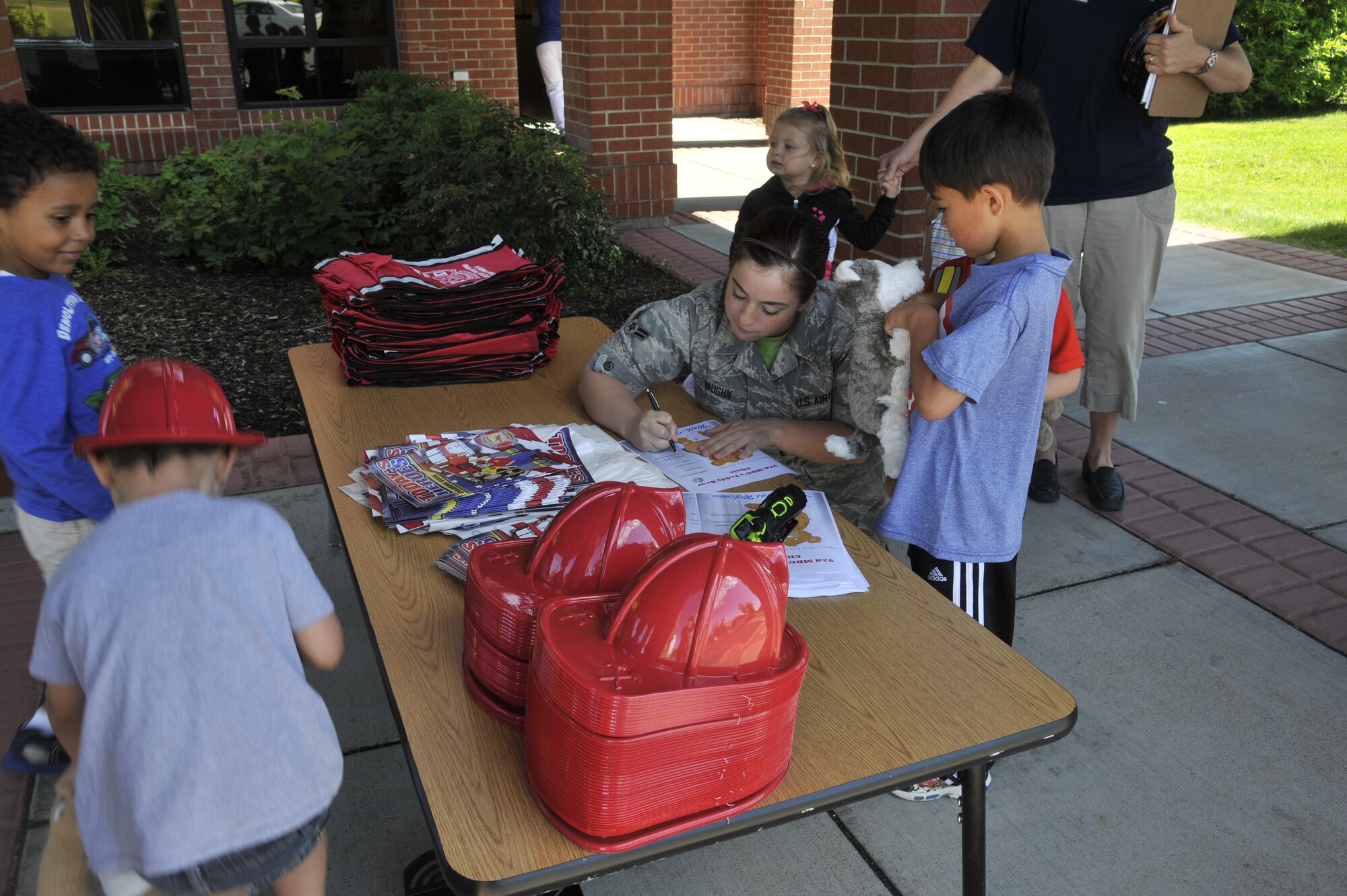 Airman 1st Class Emily Vaughn helps a student diagnose his teddy bear at the Fairchild Air Force Base, Wash., Child Development Center, June 20, 2014. Vaughn and other members of the 92nd Medical group set up a "teddy bear clinic" to teach children about emergencies and what nurses and doctors do when someone needs medical help. Vaughn is a 92nd Medical Operations Squadron medical technician. (U.S. Air Force photo by Senior Airman Mary O'Dell/Released)