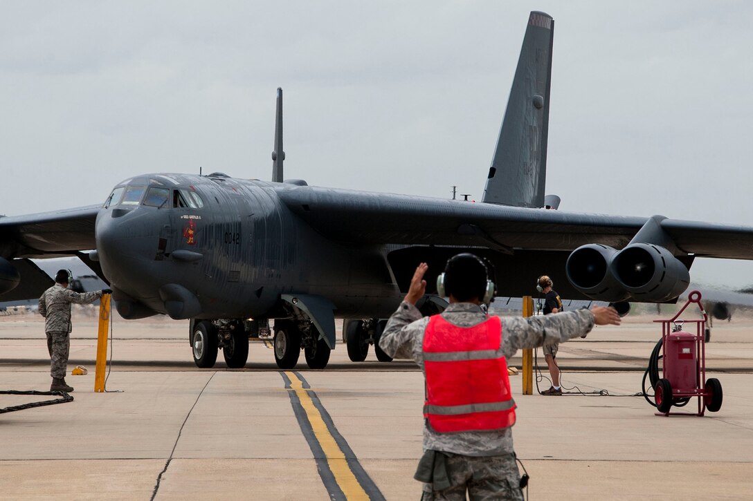 A U.S. Air Force crew chief marshals a B-52H Stratofortress after a sortie at Barksdale Air Force Base, La., June 23, 2014. The sortie marked the final flight for Col. Marty Wilson, Director of 8th Air Force Standardization and Evaluation, before his retirement from the Air Force. (U.S. Air Force photo by Master Sgt. Jeff Walston/Released)