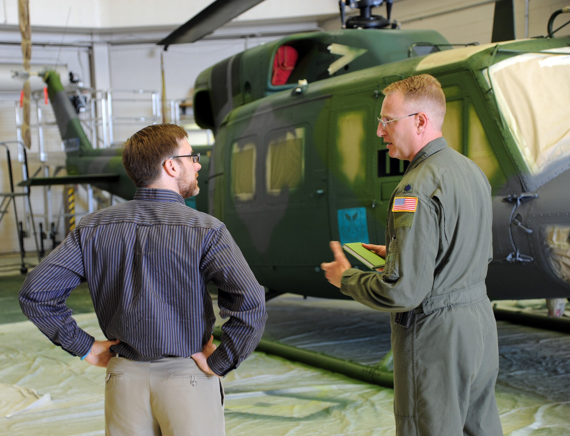 Lt. Col. John Beurer, 40th Helicopter Squadron commander, shows Dr. Jamie Morin, Assistant Secretary of the Air Force for financial management and comptroller, a decommissioned helicopter during a tour of the 40th HS on June 23. Morin visited to see key base infrastructure, Force Improvement Program initiatives and future funding requirements. (U.S. Air Force photo/ Airman 1st Class Joshua Smoot)