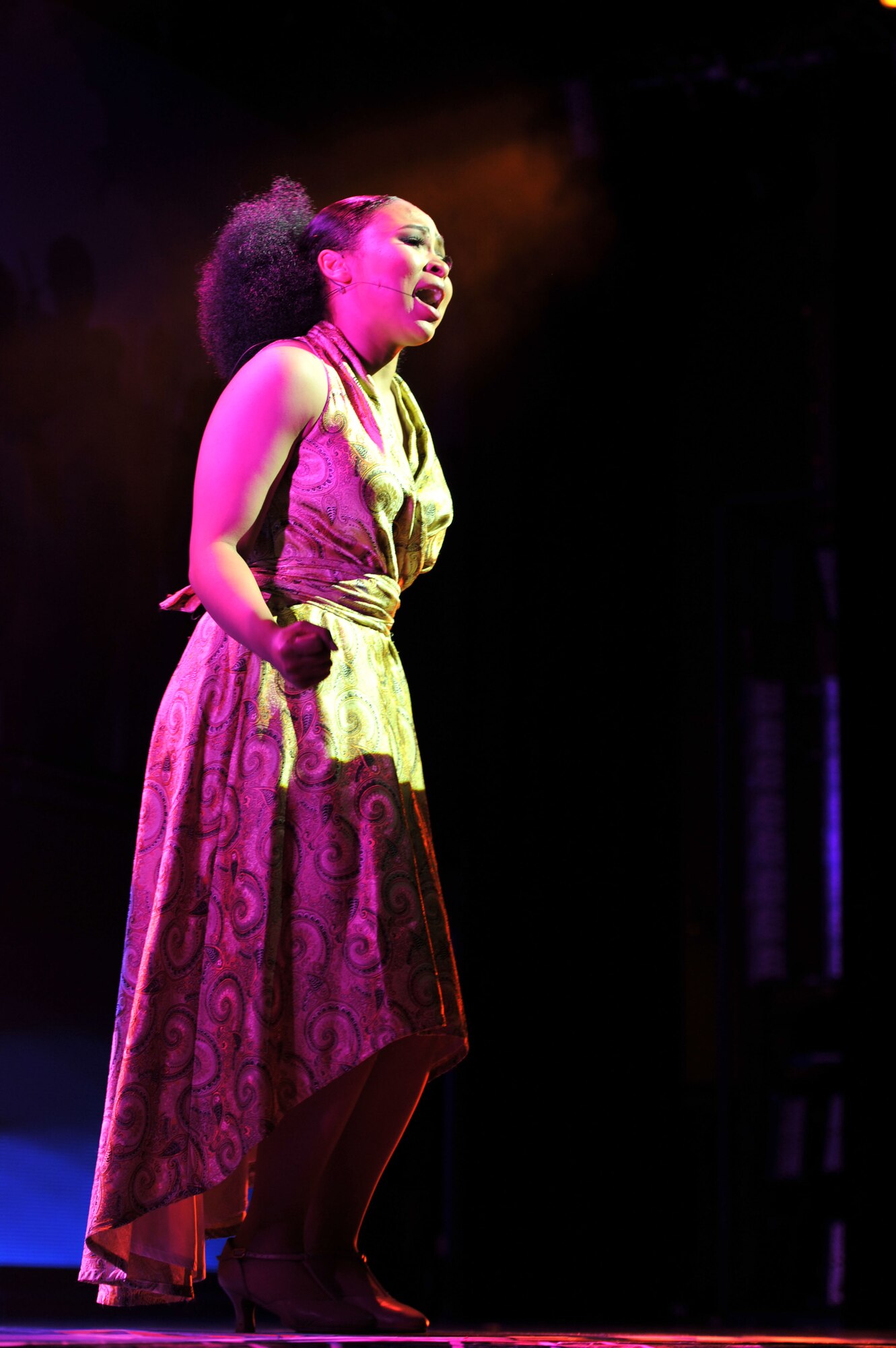 U.S. Army Pfc. Kyra White, an Army Soldier Show performer, sings during the 2014 Army Soldier Show at Fort Eustis, Va., June 24, 2014.  White is a chemical specialist assigned to Camp Stanley, South Korea, and is a Las Vegas native. (U.S. Air Force photo by Staff Sgt. Katie Gar Ward/Released)