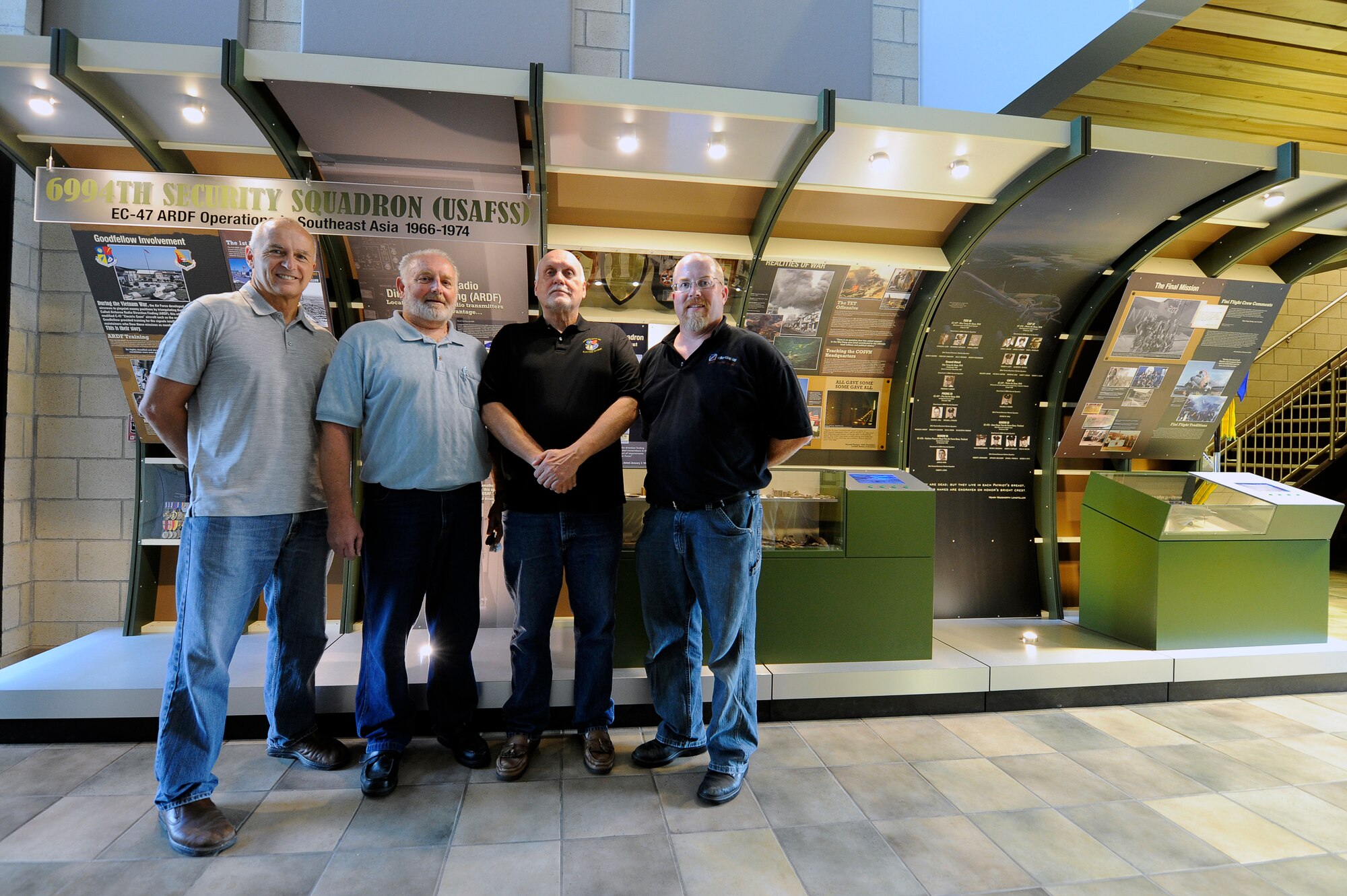 GOODFELLOW AIR FORCE BASE, Texas – John V. Garrett, Ph.D., 17th Training Wing historian, retired Chief Master Sgt. Thomas G. Nurre, Airborne Radio Direction Finding operator and exhibit coordinator, Joe Martin, ARDF operator and exhibit research and graphics coordinator, Andy Davenport, exhibit contractor, stand in front of a historical display here June 13. The exhibit was the idea of Nurre and is the culmination of nearly a year’s labor on his part.  It honors the 6994th Security Squadron’s ARDF mission during the Vietnam War and is located in the foyer of the Norma Brown Building. (U.S. Air Force photo/ Staff Sgt. Austin Knox)