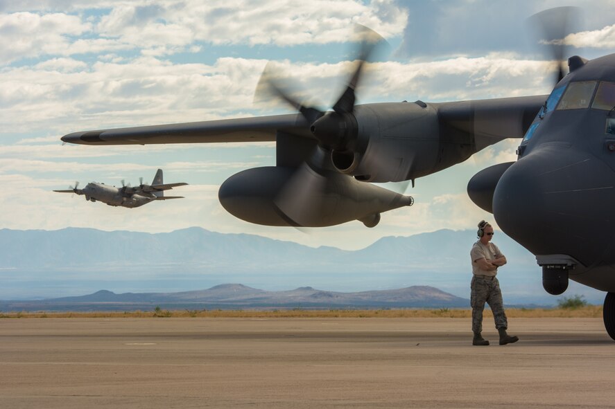Master Sgt. Paul Jones, A Crew Chief with the 106th Rescue Wing, marshals a HC-130 before take of at Fort Huachuca Ariz., on June 18, 2014. Msgt. Jones provides maintenance support to the 102d Rescue Squadron while they participate in a two-week tactics school with The Advanced Airlift Tactics Training Center attached to the 139th Airlift Wing Missouri Air National Guard. (U.S. Air National Guard photo by Senior Airman Sheldon Thompson/released)