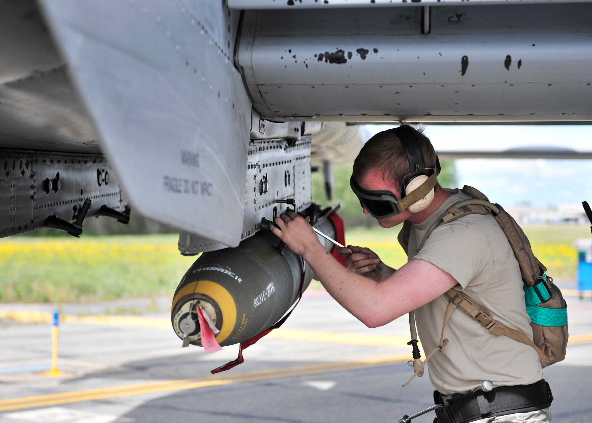 U.S. Air Force Airman 1st Class Jacob Fuller, 51st Aircraft Maintenance Squadron weapons loader assigned to Osan Air Base, South Korea, secures a live MK82 AIR munition onto an A-10 Thunderbolt II during RED Flag-Alaska 14-2 June 20, 2014, Eielson Air Force Base, Alaska. RF-A is a multi-service, multi-national training exercise that enabled combat units to sharpen their skills in multiple scenarios over a two-week period. (U.S. Air Force photo by Senior Airman Ashley Nicole Taylor/Released)