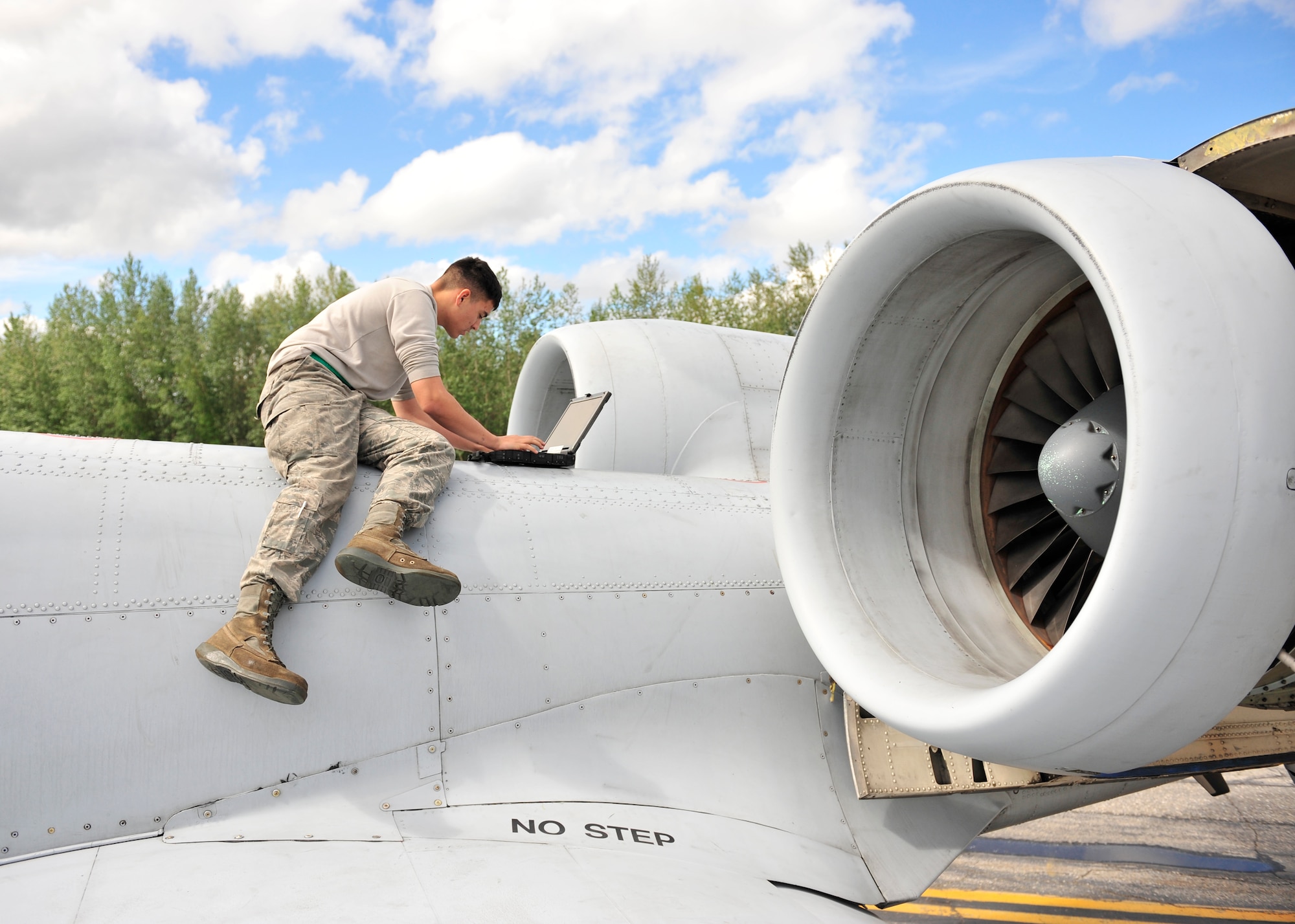U.S. Air Force Airman 1st Class Vincent Hale, 51st Aircraft Maintenance Squadron aircraft maintainer assigned to Osan Air Base, South Korea, checks a technical order during RED Flag-Alaska 14-2 June 20, 2014, Eielson Air Force Base, Alaska. The technical order displays step-by-step procedures for troubleshooting an A-10 Thunderbolt II. (U.S. Air Force photo by Senior Airman Ashley Nicole Taylor/Released)