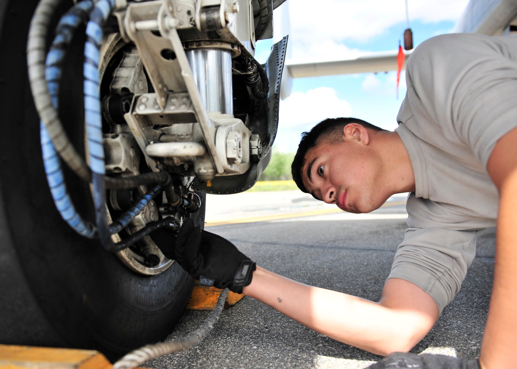 U.S. Air Force Airman 1st Class Vincent Hale, 51st Aircraft Maintenance Squadron aircraft maintainer assigned to Osan Air Base, South Korea, checks the brakes on an A-10 Thunderbolt II during RED Flag-Alaska 14-2 June 20, 2014, Eielson Air Force Base, Alaska. During RF-A exercises, participants utilized the Joint Pacific Alaska Range Complex to fly combat situations. (U.S. Air Force photo by Senior Airman Ashley Nicole Taylor/Released)