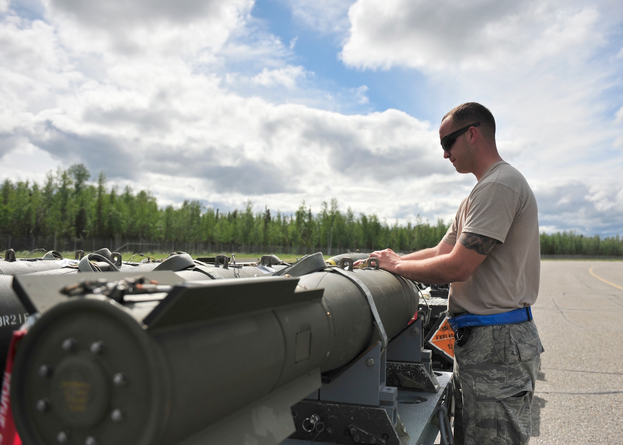 U.S. Air Force Airman 1st Class Alex Bobon, 51st Munitions Squadron weapons loader assigned to Osan Air Base, South Korea, prepares an MK82 AIR munition to load onto an A-10 Thunderbolt II during RED Flag-Alaska 14-2 June 20, 2014, Eielson Air Force Base, Alaska. The MK82 AIR is a 500-pound bomb modified with a high drag tail assembly. (U.S. Air Force photo by Senior Airman Ashley Nicole Taylor/Released)