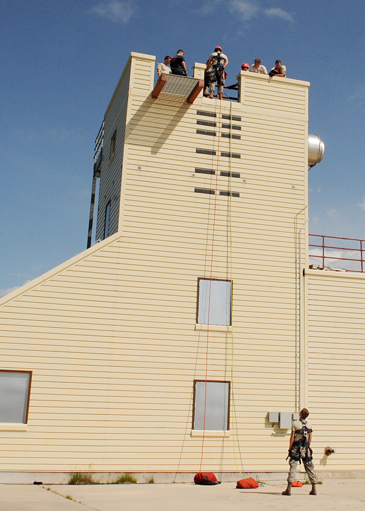 Firefighters from the 28th Civil Engineer Squadron and South Dakota National Guard 451st Engineer Detachment complete a high angle rescue exercise as part of Golden Coyote training activities at Ellsworth Air Force Base, S.D., June 17, 2014. Firefighters practiced high angle rescue techniques they would utilize if victims become stranded or trapped in a location not easily accessible from the ground. (U.S. Air Force photo by Airman 1st Class Rebecca Imwalle/ Released)