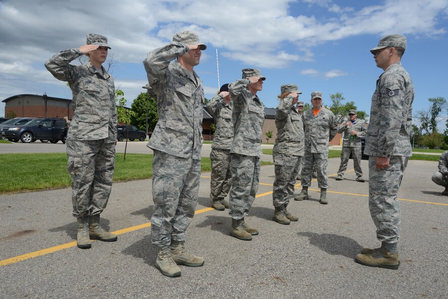Master Sgt. Michael Raby, 319th Force Support Squadron first sergeant, in orange morale shirt, observes 119th Wing Airman Leadership School students for the purposes of critique during drill evaluation at the North Dakota Air National Guard Base, Fargo, North Dakota, June 20, 2014. The ALS training prepares the Airmen for leadership roles within the Air National Guard. The five-week ALS course is among the first in the country being offered by active duty instructors at an Air National Guard base. Instructors traveling to students’ location are a cost effective way of conducting training. (U.S. Air National Guard photo/Senior Master Sgt. David H. Lipp)