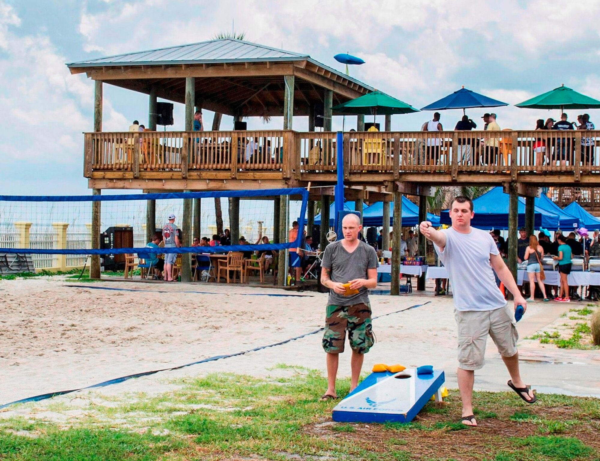 Two Airmen play a game of bean bag toss during the Junior Enlisted Appreciation Picnic June 20 at the Patrick Air Force Base, Fla., Beach House. The Patrick AFB Top 3 and the Military Affairs Committee hosted the event which was open to all military services E-6 and below. (U.S. Air Force photo/Matthew Jurgens) 