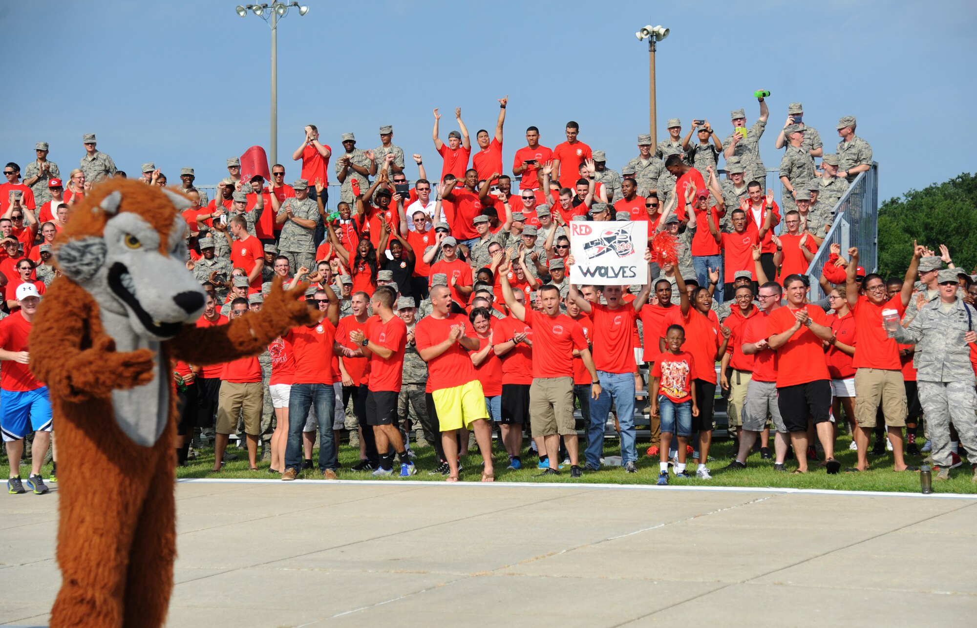 Airmen in the 336th Training Squadron react to the announcement of the Red Wolves being awarded as the overall winners during the 81st Training Group  drill down June 20, 2014, at the triangle, Keesler Air Force Base, Miss.  The 336th Red Wolves also placed first in the regulation and freestyle competitions. (U.S. Air Force photo by Kemberly Groue)