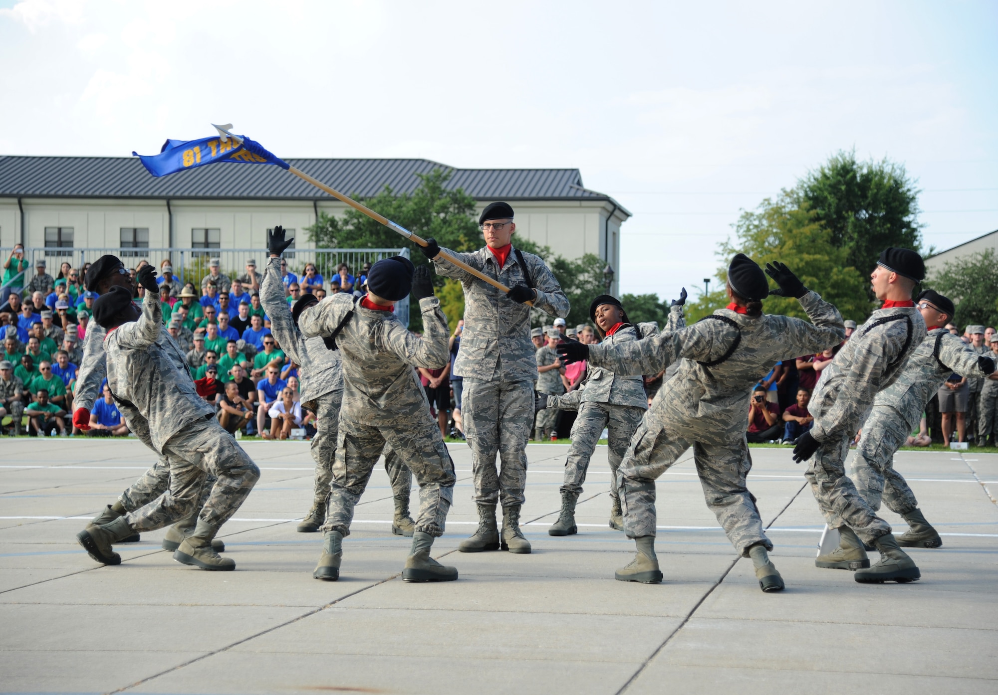 Airman 1st Class David Parkhurst, 336th Training Squadron, and team members performs during the freestyle portion of the 81st Training Group  drill down June 20, 2014, at the triangle, Keesler Air Force Base, Miss.  The 336th Rd Wolves placed first in the regulation and freestyle competitions and named as the overall winners.  (U.S. Air Force photo by Kemberly Groue)