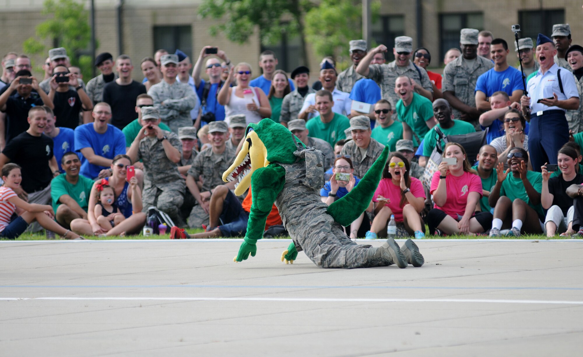 The 334th Training Squadron mascot, The Gator, performs for the crowd while waiting on results during the 81st Training Group  drill down June 20, 2014, at the triangle, Keesler Air Force Base, Miss.  The 334th Gators placed third overall.  (U.S. Air Force photo by Kemberly Groue)