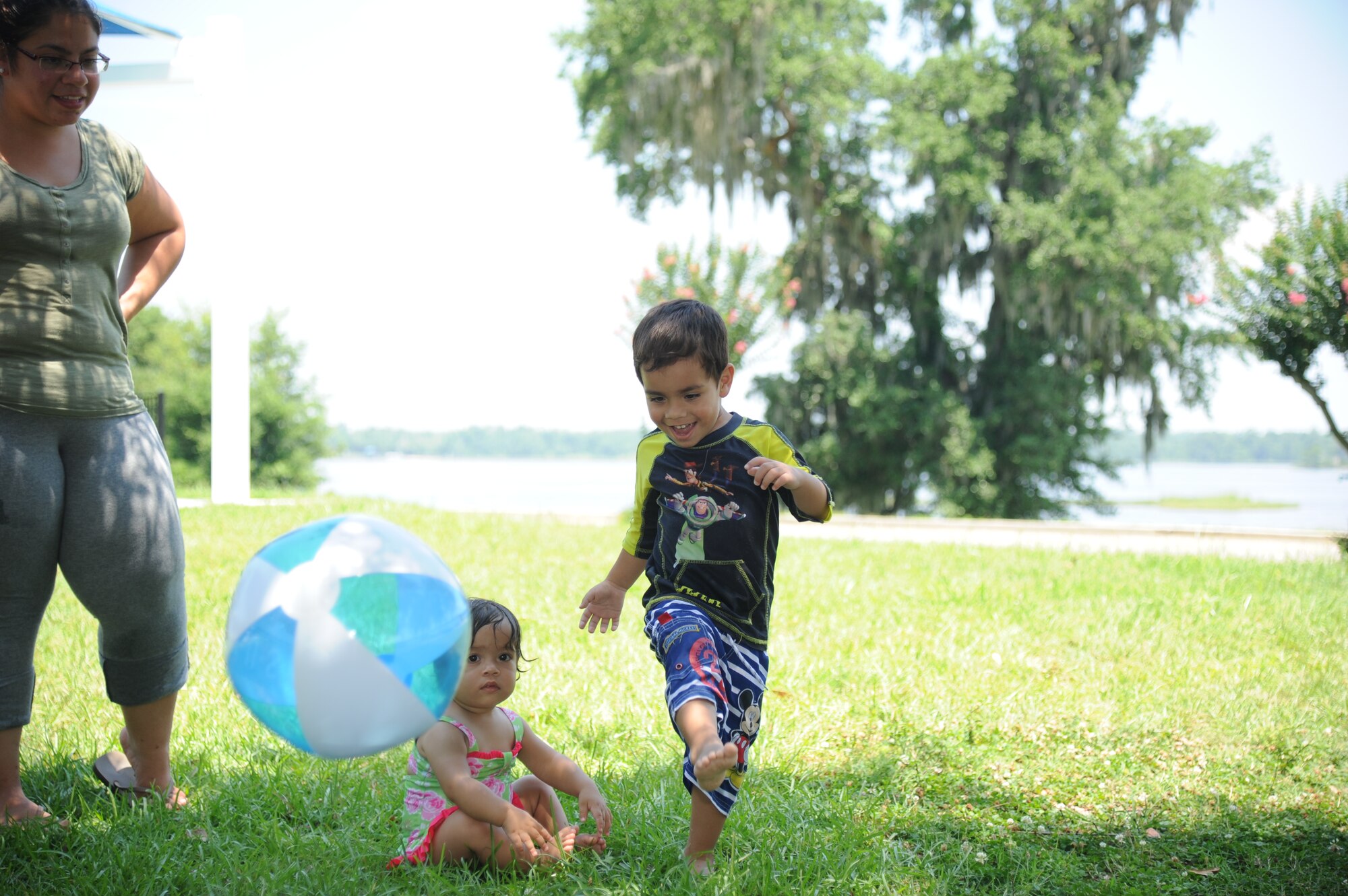 The family of Capt. Oscar Nunez, 333rd Training Squadron, kicks a ball during a deployed family picnic June 21, 2014, at the marina, Keesler Air Force Base, Miss.  The event, sponsored by the Airmen and Family Readiness Center, also included food and playtime on the splash pad.  (U.S. Air Force photo by Kemberly Groue)