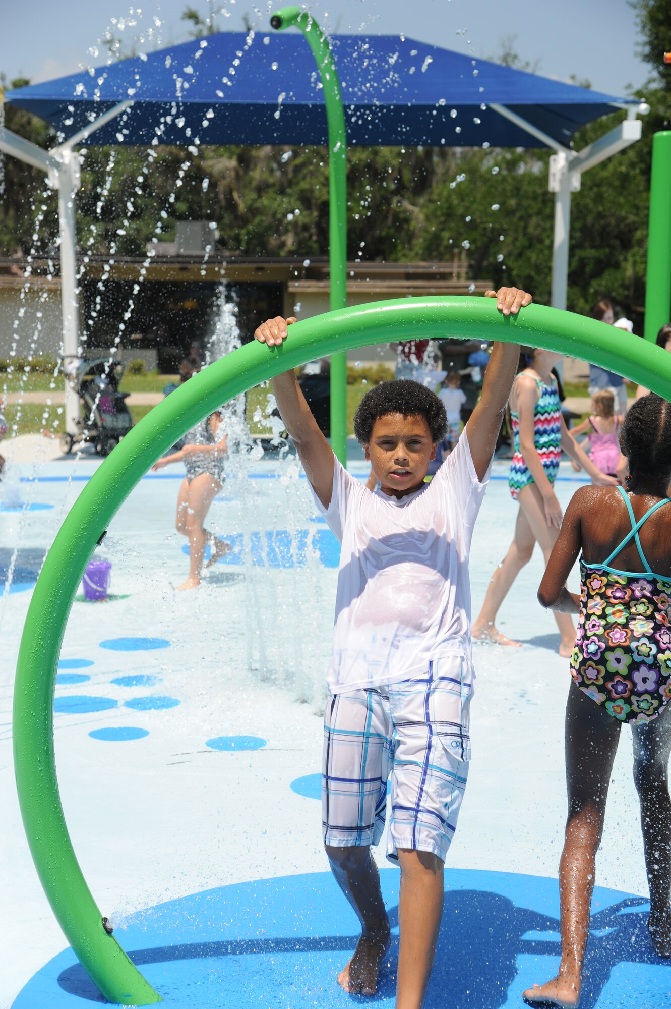 The son of Capt. Kristen Zeigler, 2nd Air Force, plays on the splash pad during a deployed family picnic June 21, 2014, at the marina, Keesler Air Force Base, Miss.  The event, sponsored by the Airmen and Family Readiness Center, also included food and games.  (U.S. Air Force photo by Kemberly Groue)