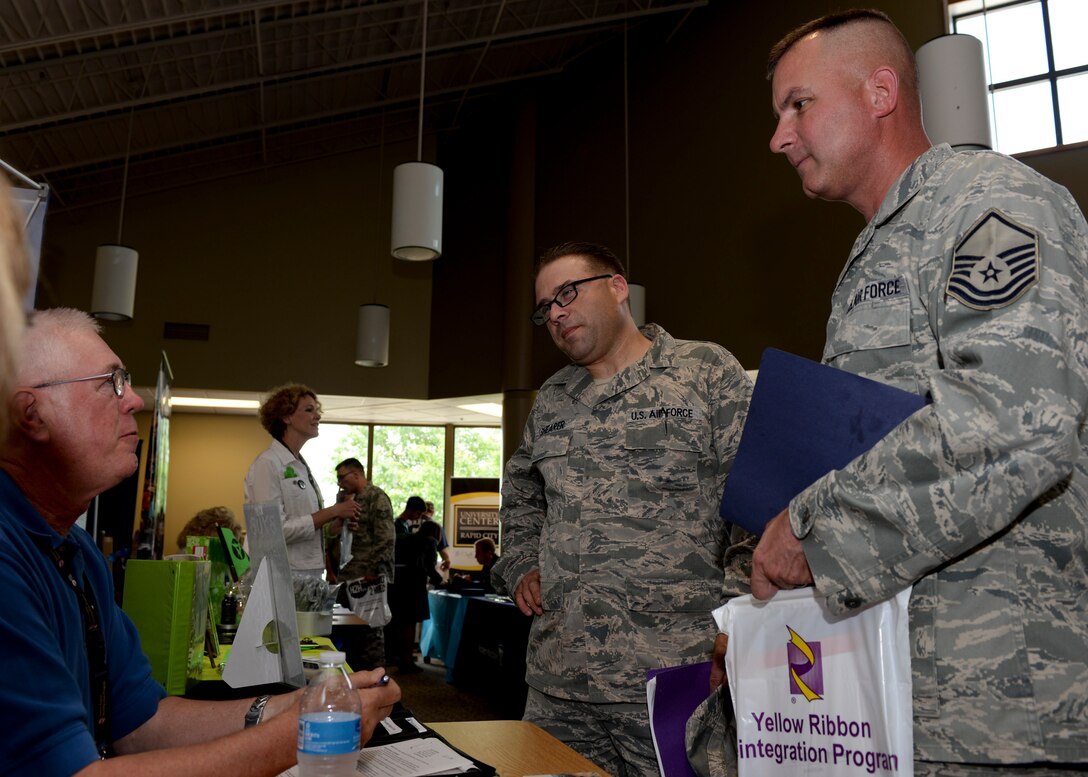 Master Sgt. James Shearer (left), 28th Communications Squadron quality assurance inspector, and Master Sgt. Marc Robson, 28th CS airfield section chief, attend the Black Hills Veterans Job Fair at Western Dakota Technical Institute, Rapid City, S.D., June, 18, 2014.  The job fair focused on linking military members and veterans with employers in the local and surrounding areas as well as nationally. (U.S. Air Force photo by Senior Airman Anania Tekurio/Released)