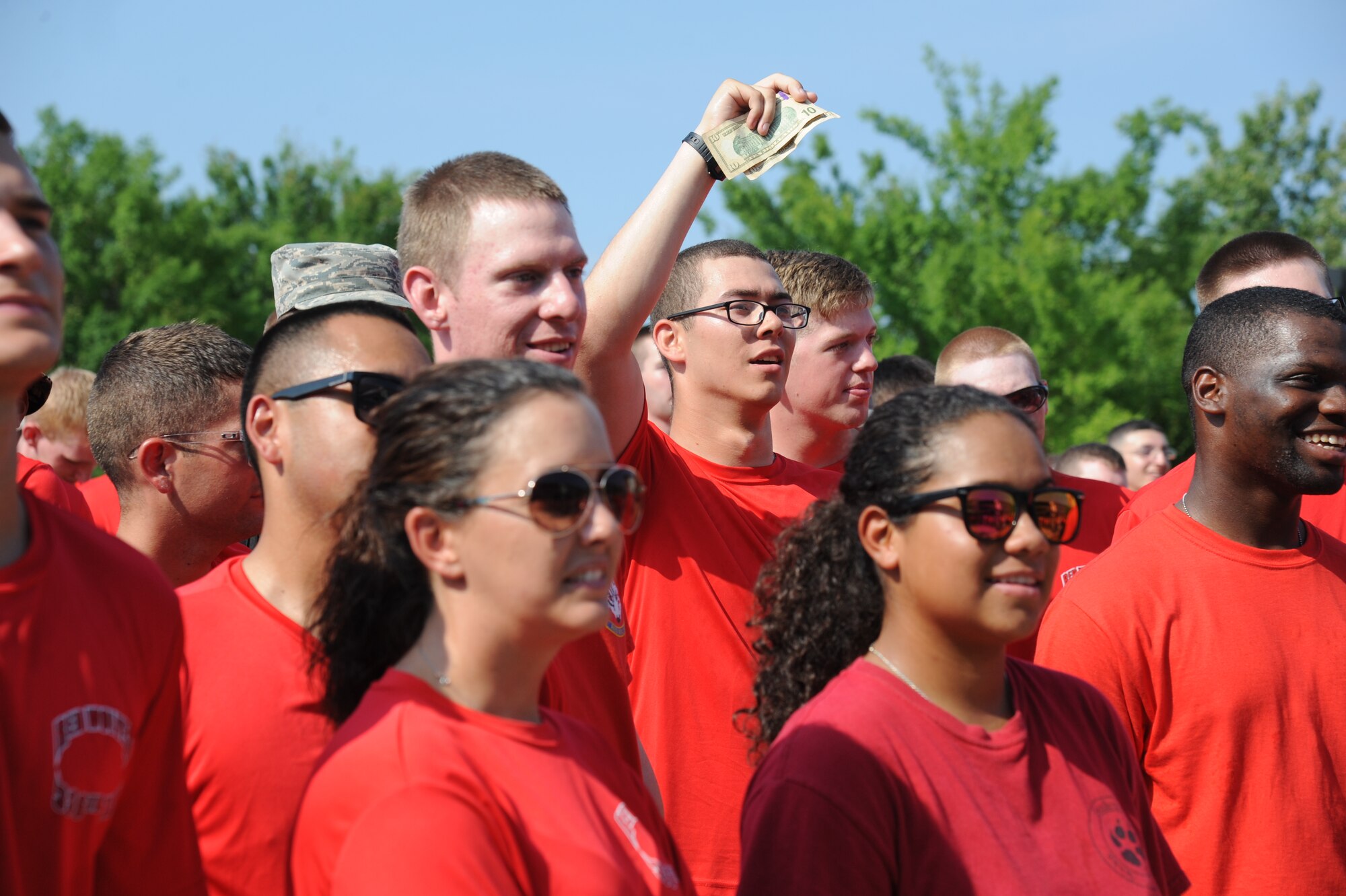 Airman 1st Class Joseph Craft, 336th Training Squadron, offers a bid to throw a pie-in-the-face of a military training leader during a squadron fundraiser June 20, 2014, at the Triangle, Keesler Air Force Base, Miss.  The squadron raised more than $1,500 to assist with the purchase of a walker for a local boy.  (U.S. Air Force photo by Kemberly Groue)