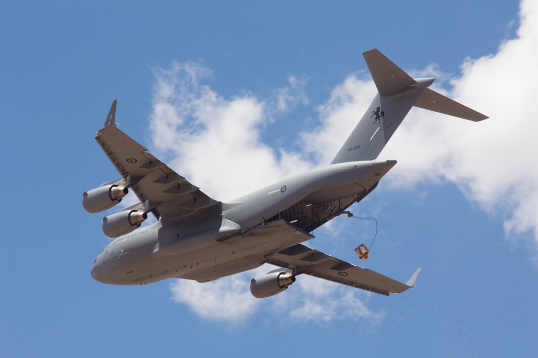 A Royal Australian Air Force C-17 Globemaster III with No. 36 Squadron (36 SQN) airdrops a simulated load above Hubar drop zone at Fort Huachuca, Ariz., June 18, 2014.  36 SQN were participating in a two-week tactics courses hosted by the AATTC attached to the 139th Airlift Wing, Missouri Air National Guard.  (U.S. Air Force photo by Senior Airman Patrick P. Evenson/Released)