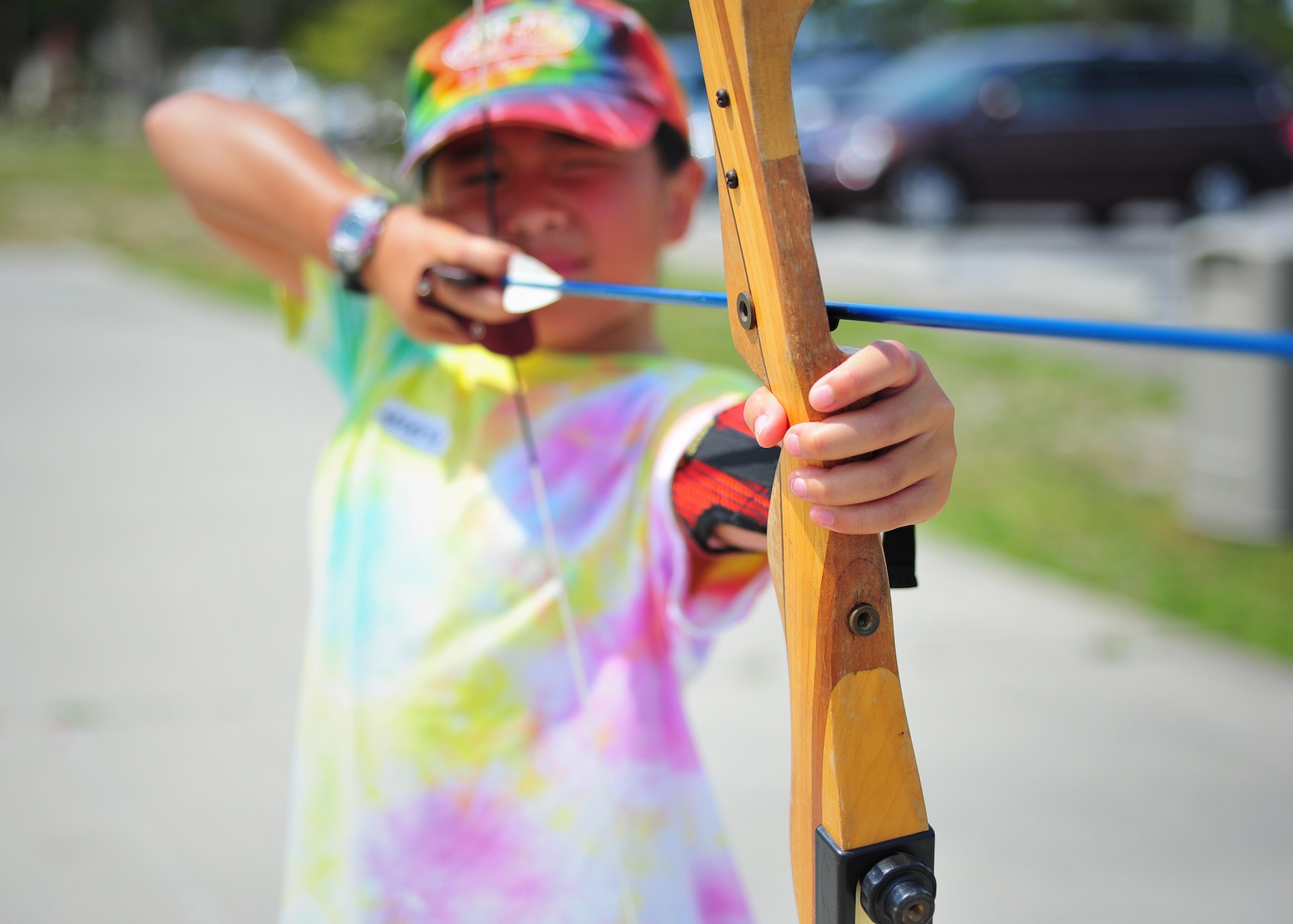 Marisa Stahl, daughter of Retired Lt. Col. Laura Stahl, draws back a bow at the Tyndall Youth Activities Center Olympic-style archery class June 23. This class is designed to be a safe environment for kids to learn the basics of archery. (U.S. Air Force photo by Airman 1st Class Dustin Mullen)