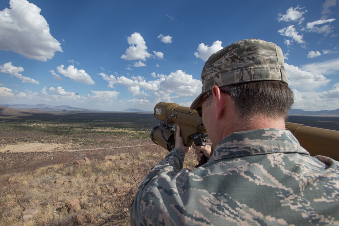 U.S. Air Force Tech Sgt. Scott Johnson, a munitions system specialist with Advanced Airlift Tactics Training Center (AATTC), Missouri Air National Guard, simulates a missile launch against a C-130 Hercules, during a training exercise at Fort Huachuca, Ariz., June 17, 2014.  Various national C-130 Hercules aircrews, participate in two-week tactics courses hosted by the AATTC attached to the 139th Airlift Wing, Missouri Air National Guard.  (U.S. Air Force photo by Senior Airman Patrick P. Evenson/Released)