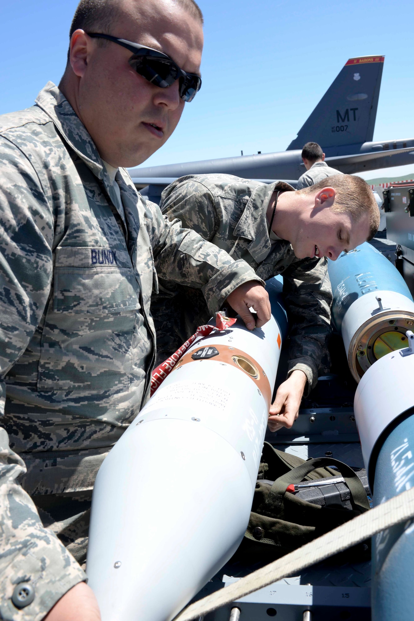 Staff Sgt. Brody Bundy and Airman Michael Page, 5th Aircraft Maintenance Squadron weapons load crew members,  prepare an inert Joint Direct Attack Munition GBU-12 to be loaded onto a B-52 Stratofortress at Ellsworth Air Force Base, S.D., June 9, 2014. For two weeks, four weapons load crew teams from Minot Air Force Base, N.D., loaded inert bombs onto several B-52s for employment during close air support training missions with U.S. Army Joint Terminal Attack Controllers. (U.S. Air Force photo by Senior Airman Anania Tekurio/Released)