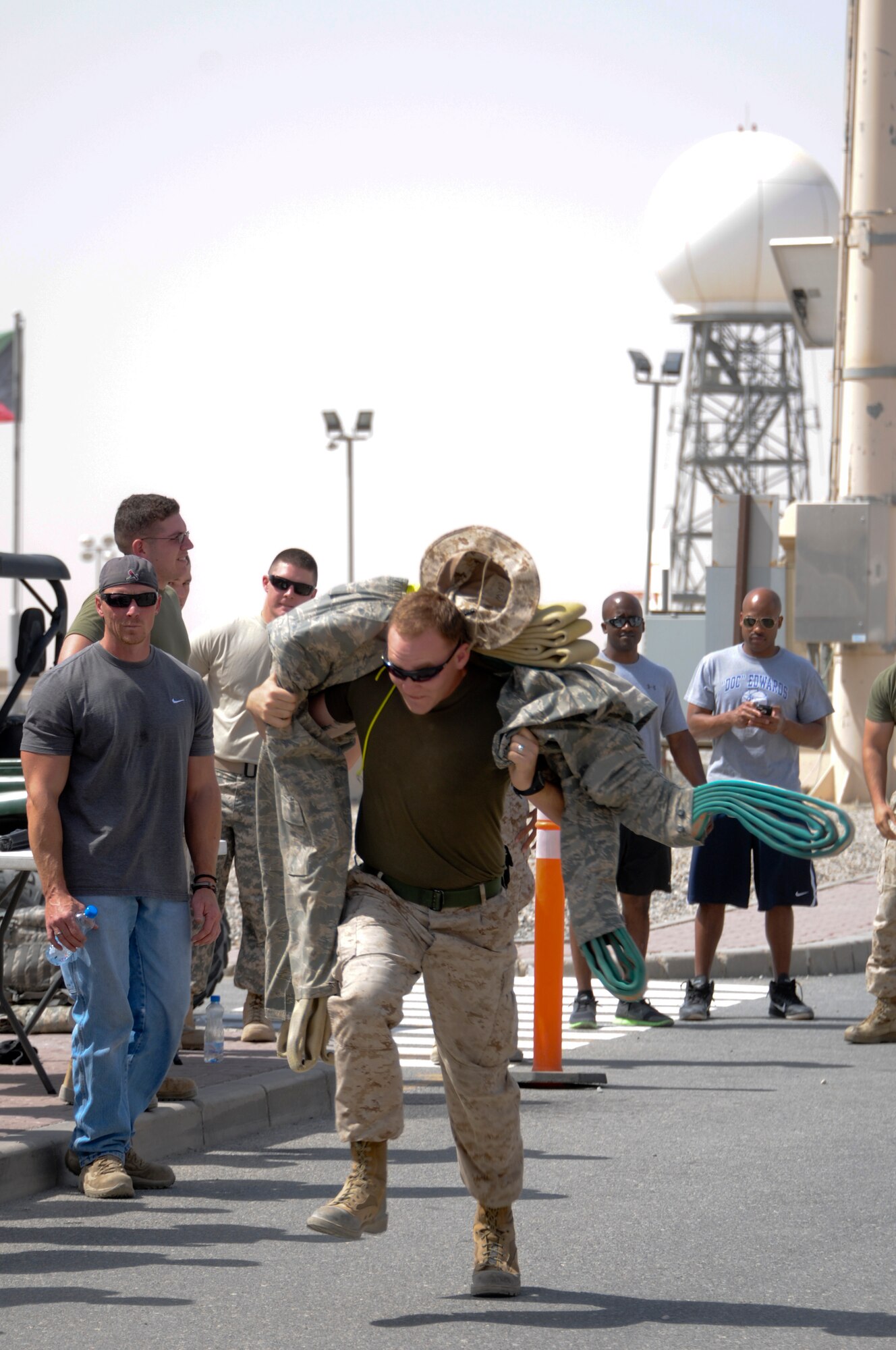 A Marine from the 2nd Law Enforcement Battalion performs a fireman's carry on a dummy during a relay race as a part of the Battle of the Badges held June 21, 2014. Military members who wear a badge for military police, fire department or explosive ordinance disposal competed against other military members in multiple events including a ruck march, MRAP pull and relay race to earn the title of best badge wearer. (U.S. Air Force photo by 1st Lt. Holli Nelson)